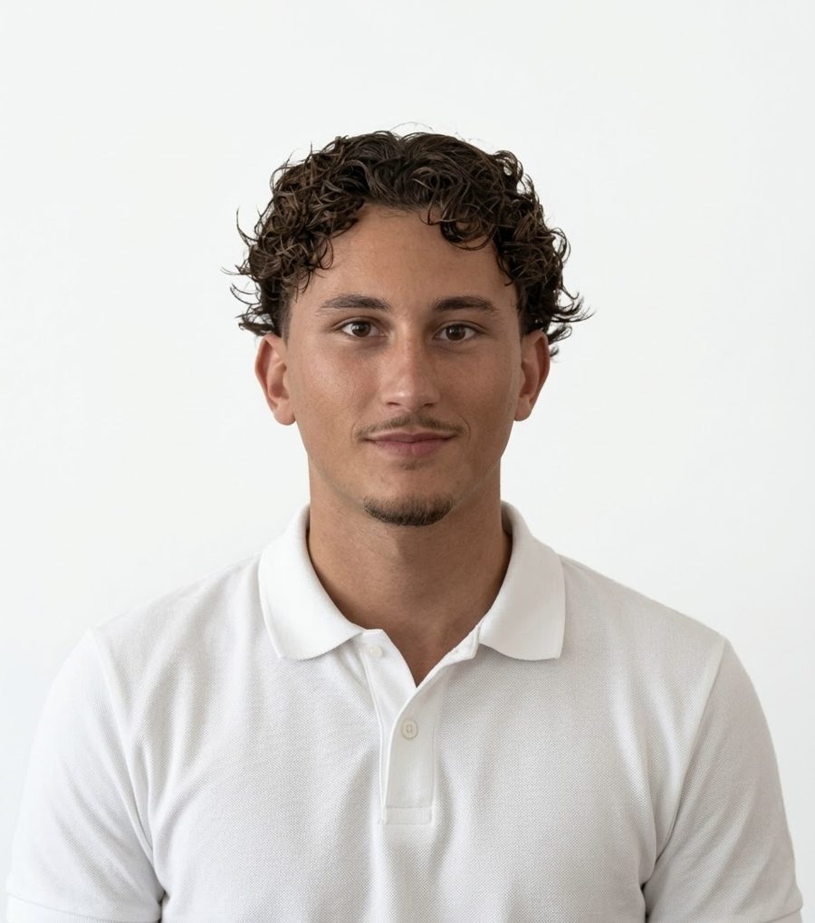 Portrait of Sacha Loskov, smiling, in a white polo shirt